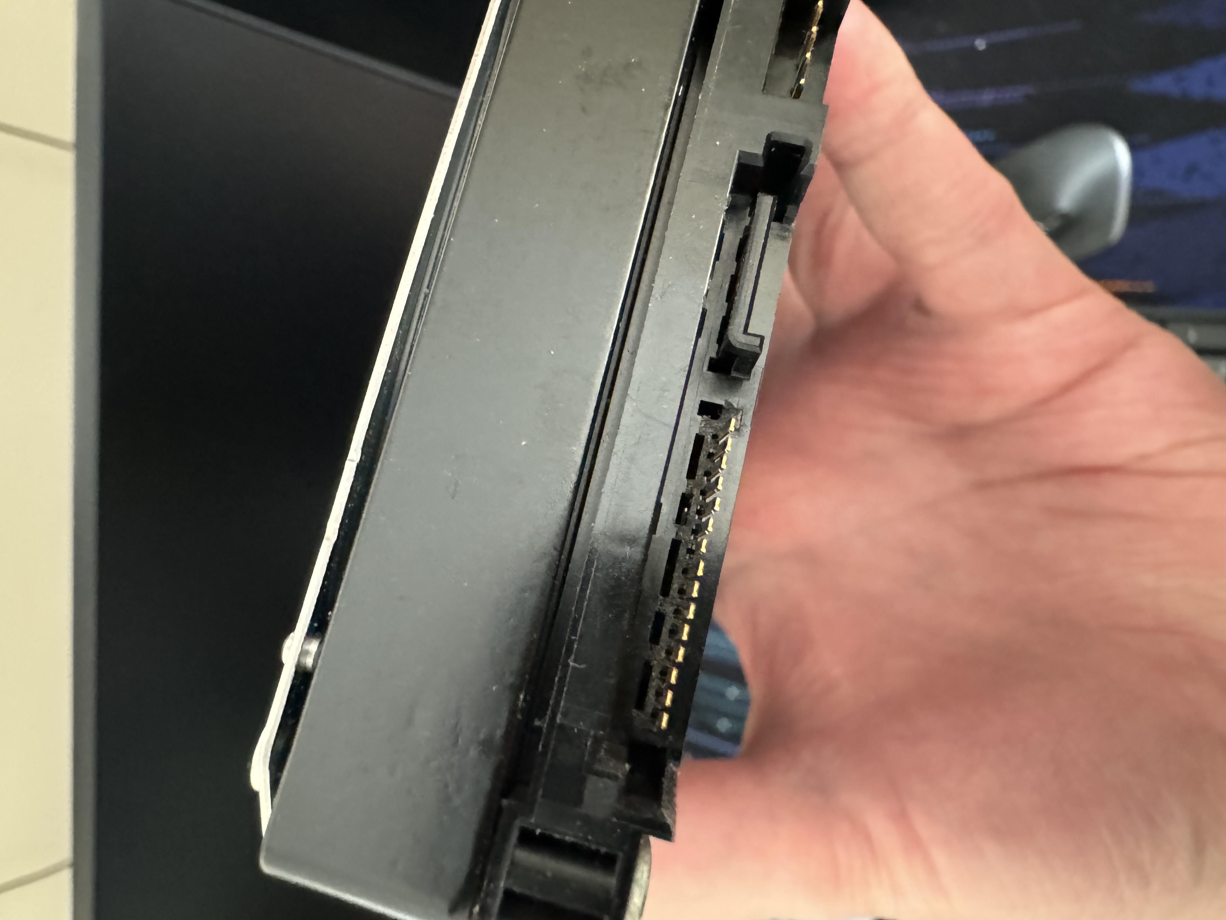 A hard drive with a broken SATA power connector